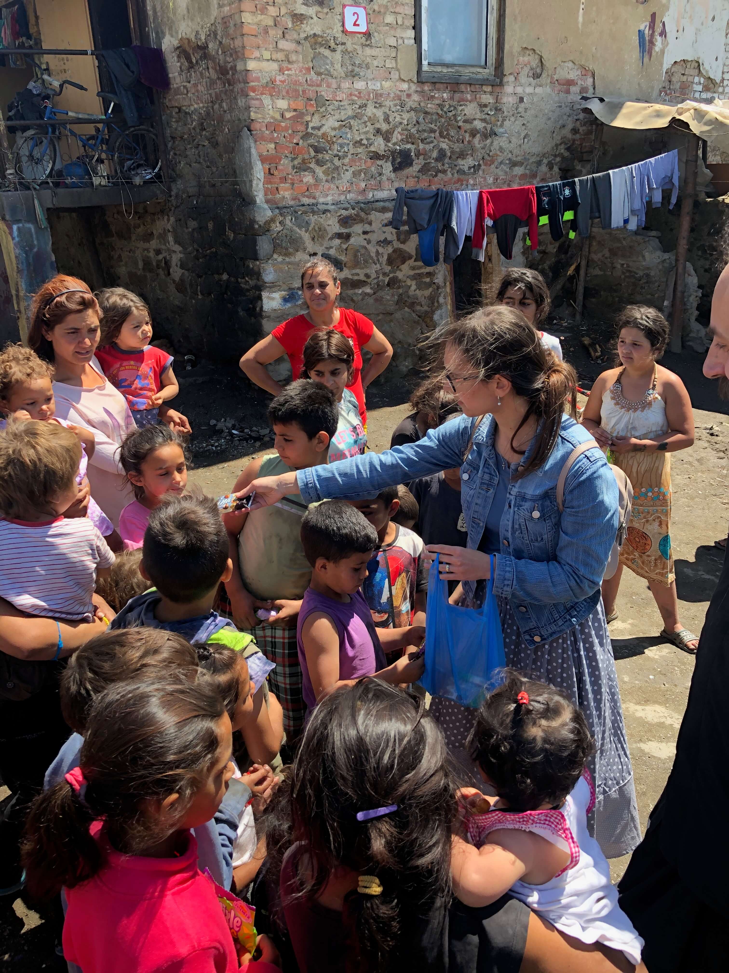 Michalka distributing sweets to children at the cross blessing celebration, Mútnik 2020